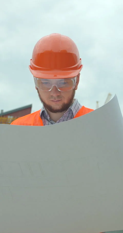 Vertical video. Young architect with hard hat holding blueprint Stock Footage 345502983