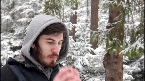 Vertical video of a young bearded man enjoying hot tea Stock Footage 329499220