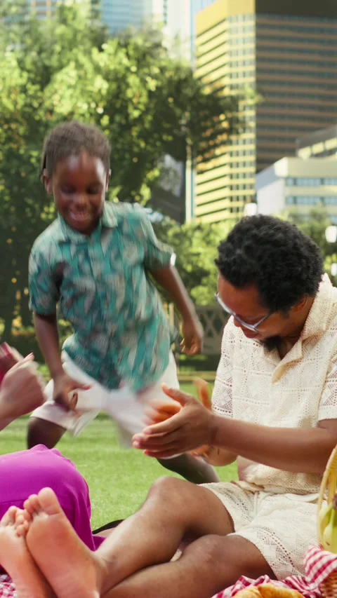 Vertical Video Young boy dancing and having fun with parents on checkered Stock Footage 341471672