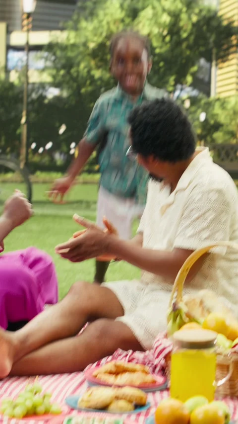 Vertical Video Young boy dancing and having fun with parents on checkered Stock Footage 341472925