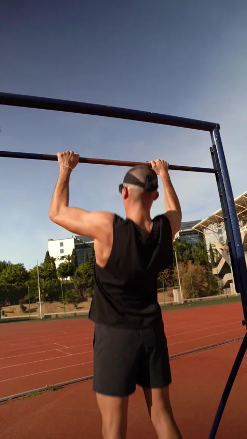 Vertical video of a young boy performing barbell pull-ups. Concept of prepa.. Stock Footage 267894490
