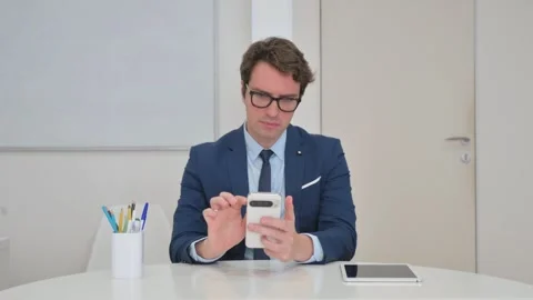 Vertical Video, Young Businessman Browsing Internet on Smartphone Video stock 312914190