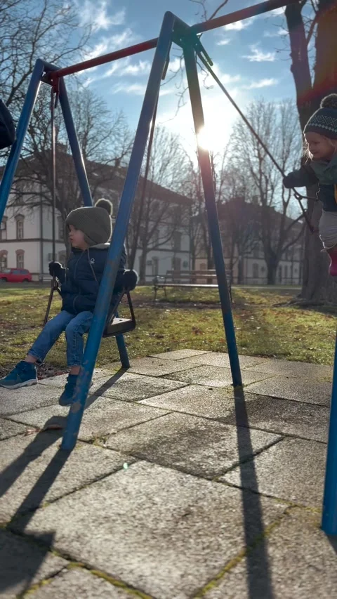 Vertical Video of Young Child Riding Playground Swing Stock Footage 345159943