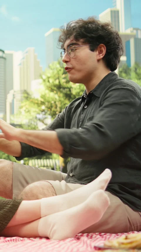 Vertical Video Young couple sitting and talking on romantic picnic date together Stock Footage 341473163