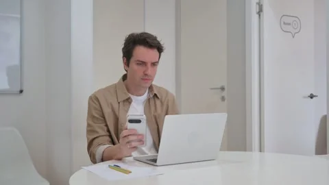 Vertical Video, Young Creative Man Using Phone and Typing on Laptop Stock Footage 312914004