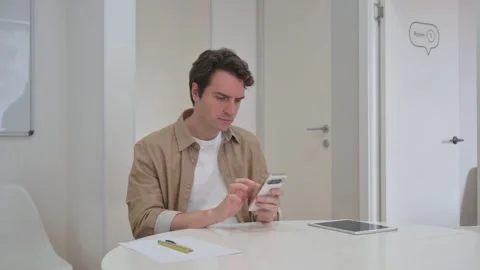 Vertical Video, Young Creative Man Typing Message on Phone Video stock 312914091