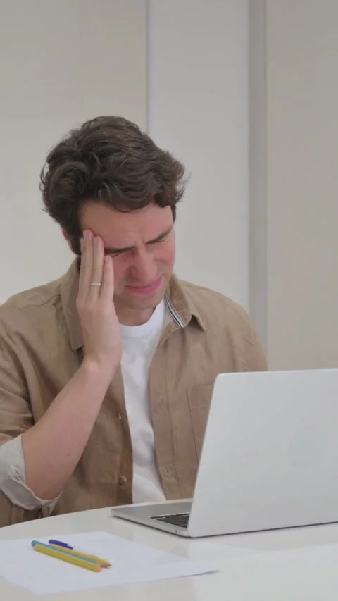 Vertical Video, Young Creative Man with Headache Typing on Laptop Video stock 318044333