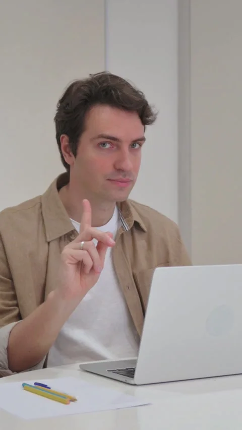 Vertical Video, Young Creative Man in Denial Looking at Camera While Working on Stock Footage 318044911