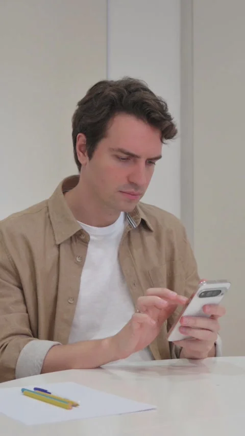 Vertical Video, Young Creative Man Typing Message on Phone Stock Footage 318045536