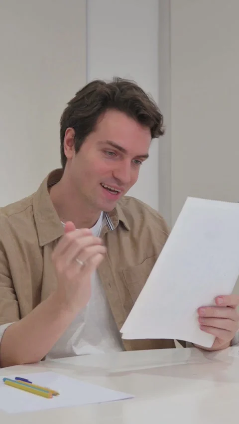 Vertical Video, Young Creative Man Celebrating Documents at Work Stock Footage 318045736