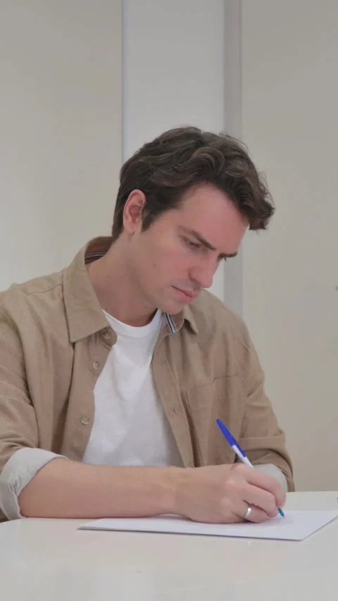 Vertical Video, Young Creative Man Writing a Business Letter Stock Footage 318045958