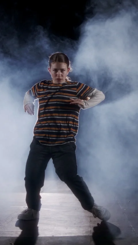 Vertical Video of young female dancer performing hip hop dance with strobe light Stock Footage 251556871