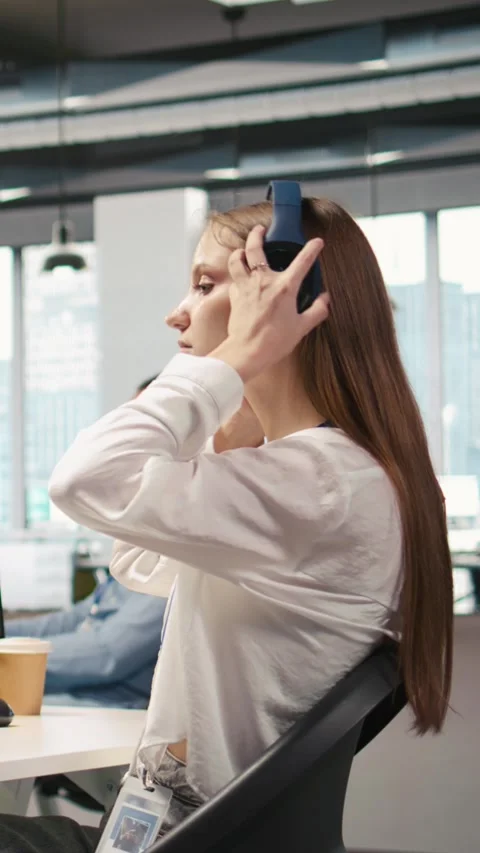Vertical video Young female programmer in office reviewing AI system metrics Stock Footage 312709182