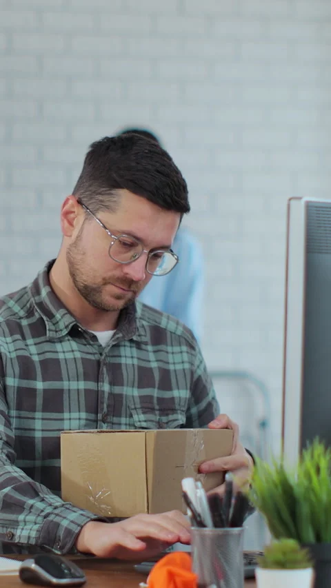 Vertical video. Young man and woman working on computer and sorting Stock Footage 345730027
