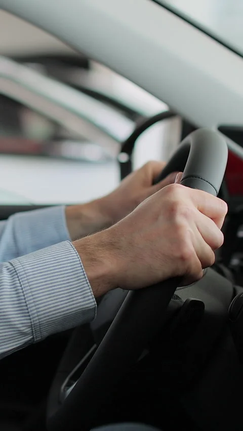 Vertical video Young man auto driver car owner holding steering wheel Stock Footage 337236338