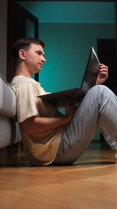 Vertical video young man concentrating on his computer, sitting casually on a Stock Footage 342766878