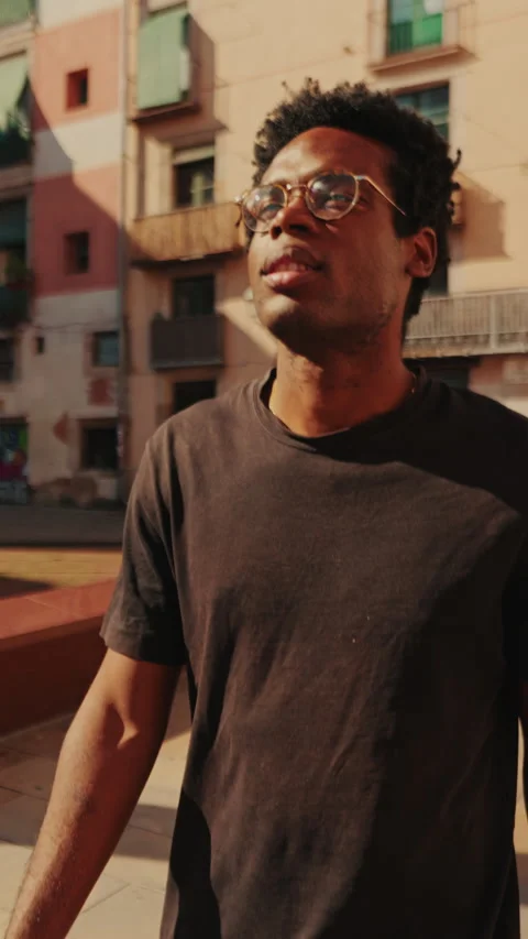 Vertical video, Young Man Exploring a Sunny City Square Stock Footage 316572035