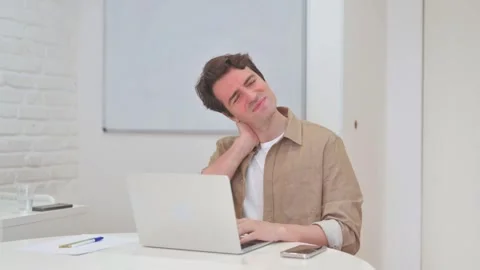 Vertical Video, Young Man having Neck Pain while Working on Laptop 스톡 동영상 312914297