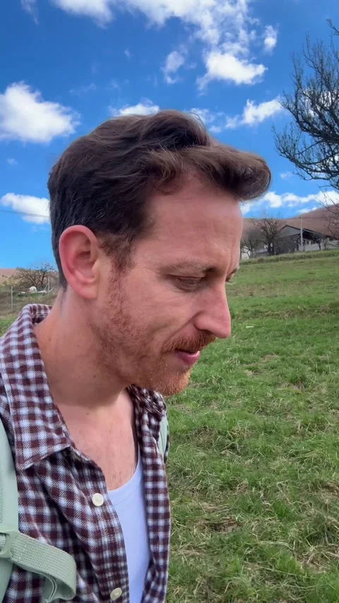 Vertical Video Young man, influencer filming live stream, video in nature Stock Footage 345362161