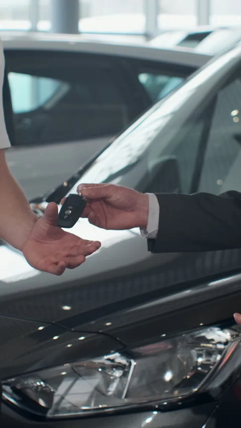 Vertical Video Young man selling car, handshake at car dealership Stock Footage 337879133
