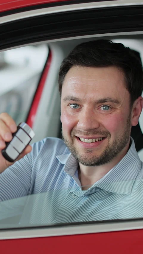 Vertical video Young man showing key to new car. Видео 337237920