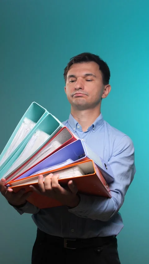 Vertical video young man standing burdened with a large stack of colorful ring Stock Footage 342771190