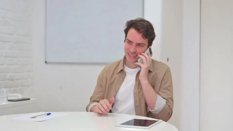 Vertical Video, Young Man Talking on phone with Client Video stock 312914472
