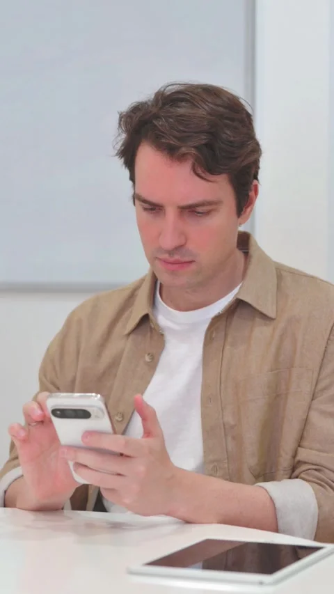 Vertical Video, Young Man Typing Message on Phone Stock Footage 318049015