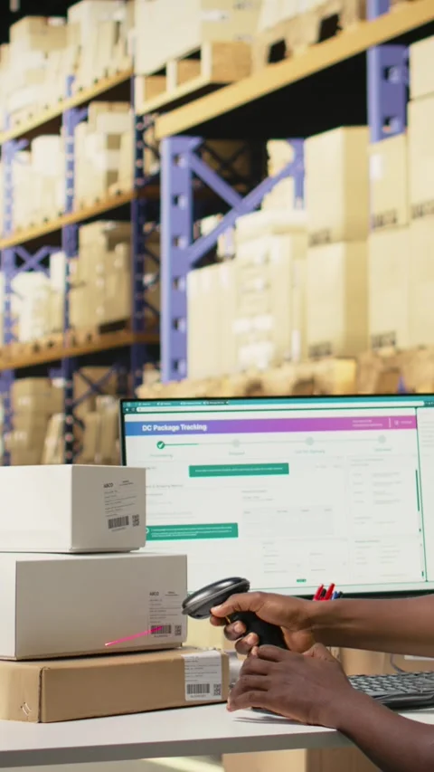 Vertical Video Young man using scanner on barcodes and applying tags in Stock Footage 315191021