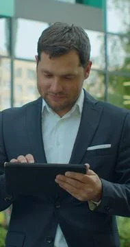 Vertical video. Young Professional Using Digital Tablet in Office District. Foto stock