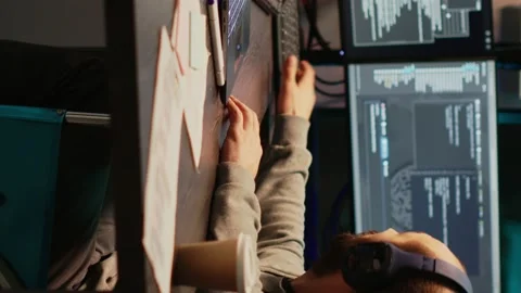 Vertical video: Young programmer typing source code in office Stock Footage 221797402
