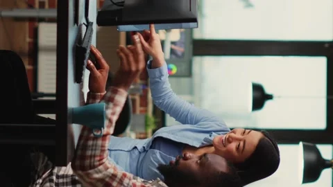Vertical video: Young team of professional developers using skills Stock Footage 223601674