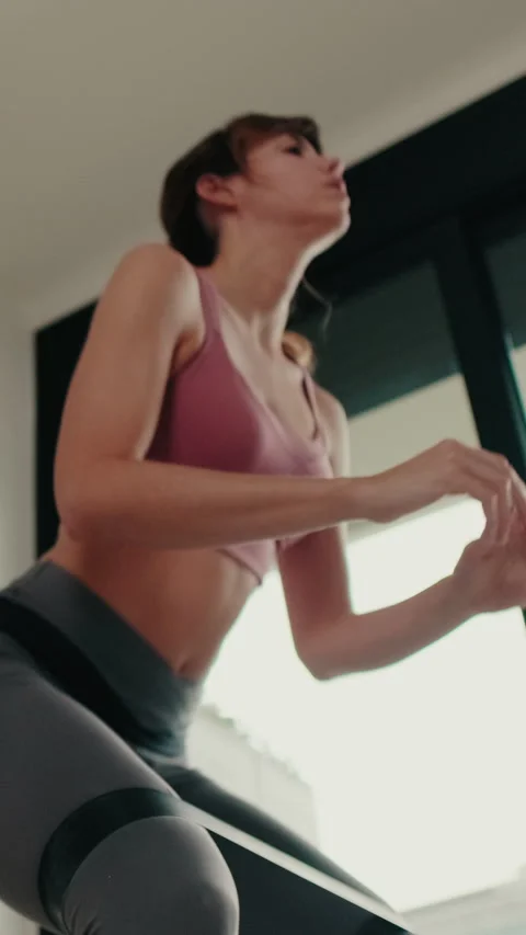 Vertical video, Young Woman Doing Squats At Home Stock Footage 307959863