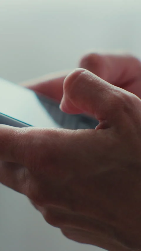 Vertical video. Young woman using smartphone in living room, typing message. Stock Footage 345056324