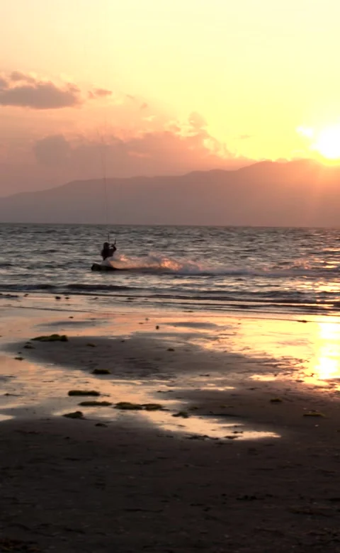 Vertical video.Surfer windsurfing during a sunset Stock Footage 257569630