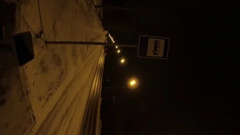 Vertical video.Vertical shot. Bus stop at night on the highway. Urn for garbage. Stock-Footage 87591814