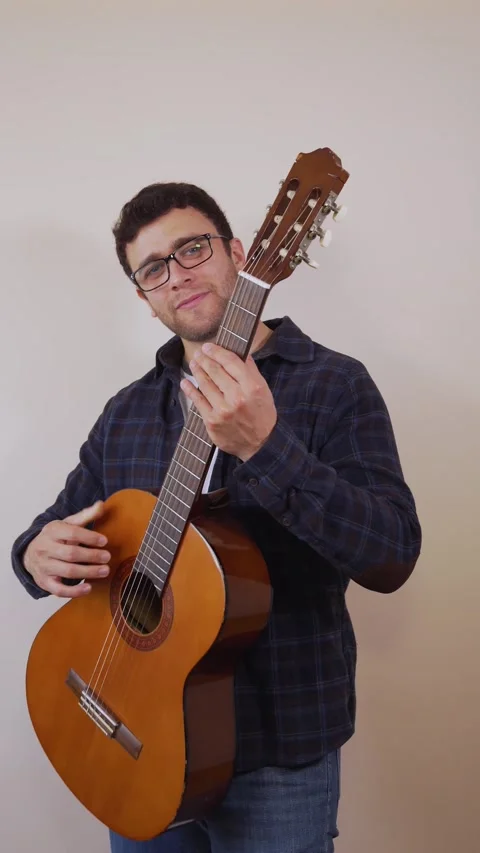 Vertical video.white man. Invited to play the acoustic guitar Stock Footage 236678027