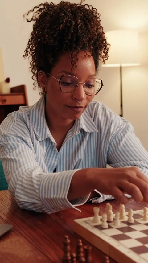 Vertical video,Woman Playing Chess Online on Laptop Stock Footage 310015666