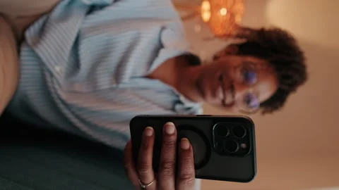 Vertical video,Woman Relaxes on Couch Using Phone Stock Footage 312184437