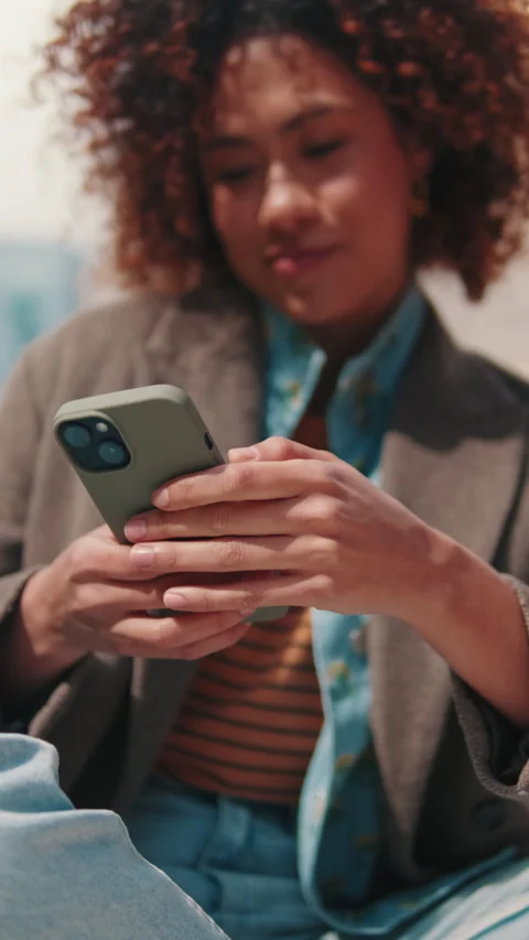 Vertical video,Woman Using Smartphone App Outdoors Stock Footage 303778953