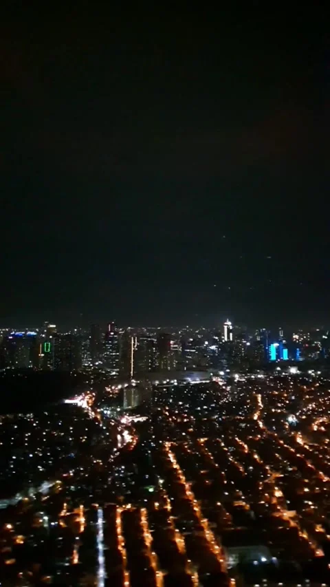 Vertical view from an aircraft window during night flight approaching city for l Stock Footage 331888145