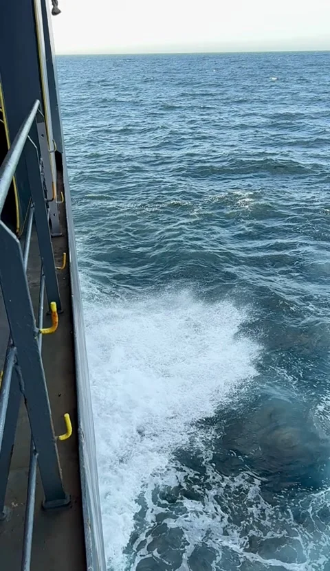 Vertical View Along Ship Side with Ocean Water During Voyage Stock Footage 336589900
