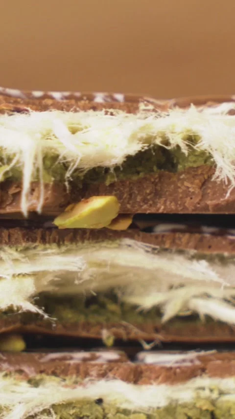 Vertical View of Artisanal Dubai Chocolate Topped with Crushed Nuts 스톡 동영상 314657355