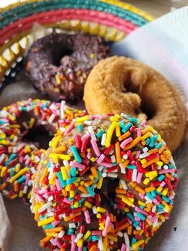 Vertical View of Assorted Gourmet Donuts with Colorful Sprinkles 写真素材