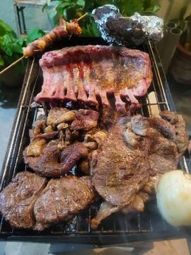Vertical view of Assorted Meats Grilling on a Charcoal Barbecue Stock Photos