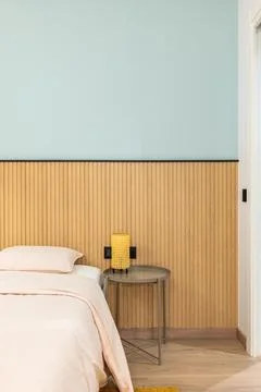 Vertical view of a bed with pillow with large warm duvet and linens in pleasant Stock Photos
