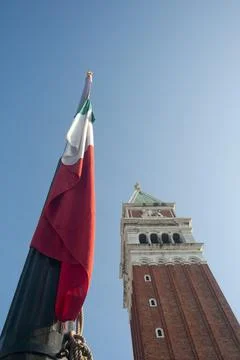 Vertical view of the bell tower and an Italian flag Fotos de archivo