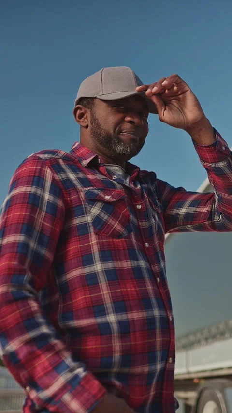 Vertical view from below of confident African American man adjusting his cap Stock Footage 306581041