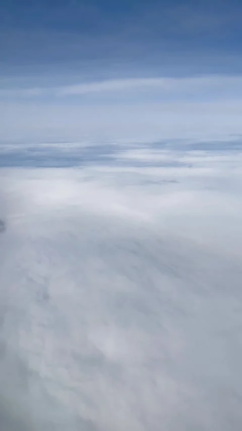 Vertical View of the blue Sky above the clouds from the airplane window Stock Footage 306670110