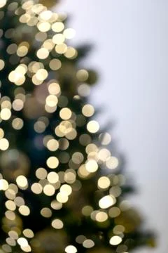 Vertical view of blurred christmas tree with garlands. Stock Photos